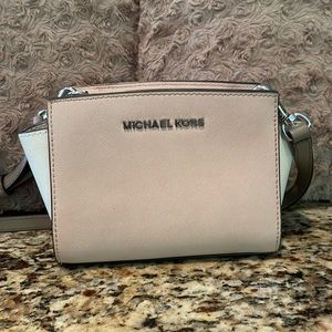 Small pink Michael Kors purse with silver accents.